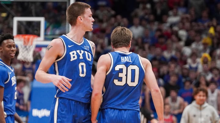 Feb 27, 2024; Lawrence, Kansas, USA; Brigham Young Cougars guard Dallin Hall (30) celebrates with forward Noah Waterman (0) after scoring against the against the Kansas Jayhawks during the second half at Allen Fieldhouse. Mandatory Credit: Denny Medley-USA TODAY Sports
