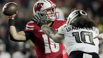Wisconsin quarterback Braedyn Locke (18) is pressured by Oregon defensive end Matayo Uiagalelei (10) during the first quarter of their game Saturday, November 16, 2024 at Camp Randall Stadium in Madison, Wisconsin.