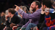 Jan 27, 2025; New York, New York, USA; Actor and comedian Adam Sandler reacts while sitting court side during the second half of the NBA between the New York Knicks and the Memphis Grizzlies at Madison Square Garden. Mandatory Credit: Vincent Carchietta-Imagn Images