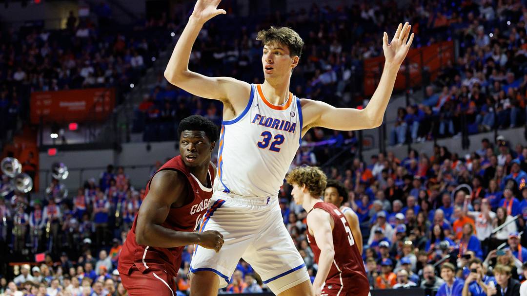 Dec 21, 2025; Gainesville, Florida, USA; Florida Gators center Olivier Rioux (32) calls for the ball while Colgate Raiders guard Josh Ahayere (4) defends during the second half at Exactech Arena at the Stephen C. O'Connell Center. Mandatory Credit: Matt Pendleton-Imagn Images