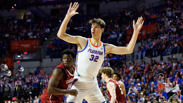 Dec 21, 2025; Gainesville, Florida, USA; Florida Gators center Olivier Rioux (32) calls for the ball while Colgate Raiders guard Josh Ahayere (4) defends during the second half at Exactech Arena at the Stephen C. O'Connell Center. Mandatory Credit: Matt Pendleton-Imagn Images