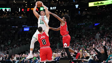 Jan 9, 2023; Boston, Massachusetts, USA; Boston Celtics forward Grant Williams (12) grabs the rebound against Chicago Bulls guard Zach LaVine (8) and guard Coby White (0): David Butler II-Imagn Images