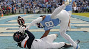 Oct 25, 2025; Chapel Hill, North Carolina, USA; North Carolina Tar Heels defensive back Jaiden Patterson (18) breaks up a pass in the end zone intended for Virginia Cavaliers wide receiver Jahmal Edrine (7) in overtime at Kenan Stadium. Mandatory Credit: Bob Donnan-Imagn Images