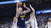 Mar 10, 2025; Oklahoma City, Oklahoma, USA; Denver Nuggets center Nikola Jokic (15) goes up for a basket against Oklahoma City Thunder center Isaiah Hartenstein (55) during the second quarter at Paycom Center. Mandatory Credit: Alonzo Adams-Imagn Images