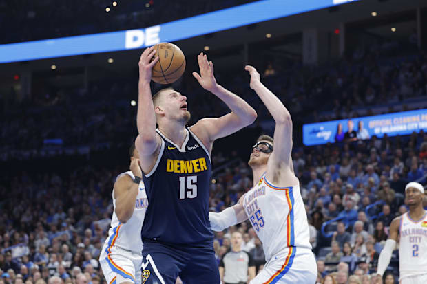 Denver Nuggets center Nikola Jokic (15) goes up for a basket against Oklahoma City Thunder center Isaiah Hartenstein (55)