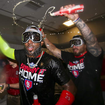 Oct 9, 2019; Atlanta, GA, USA; St. Louis Cardinals left fielder Marcell Ozuna (23) and shortstop Paul DeJong (12) celebrate after defeating the Atlanta Braves in game five of the 2019 NLDS playoff baseball series at SunTrust Park. Mandatory Credit: Brett Davis-Imagn Images