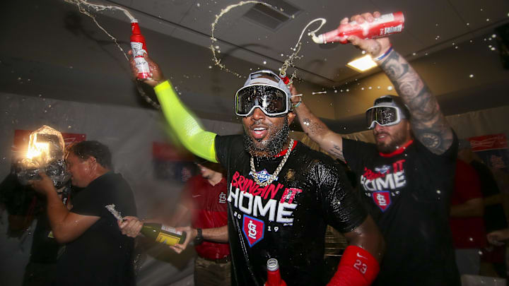 Oct 9, 2019; Atlanta, GA, USA; St. Louis Cardinals left fielder Marcell Ozuna (23) and shortstop Paul DeJong (12) celebrate after defeating the Atlanta Braves in game five of the 2019 NLDS playoff baseball series at SunTrust Park. Mandatory Credit: Brett Davis-Imagn Images