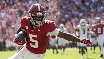 Oct 12, 2024; Tuscaloosa, Alabama, USA; Alabama Crimson Tide wide receiver Germie Bernard (5) scores after catching a pass from Alabama Crimson Tide quarterback Jalen Milroe (4) to seal the victory at Bryant-Denny Stadium. Alabama defeated South Carolina 27-25. Mandatory Credit: Gary Cosby Jr.-Imagn Images