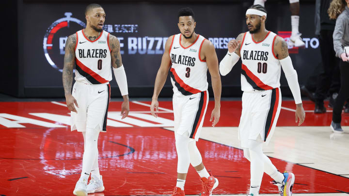 Mar 19, 2021; Portland, Oregon, USA; (L-R) Portland Trail Blazers Damian Lillard (0), CJ McCollum (3) and Carmelo Anthony (00) walk back to the court after a timeout during the second half against the Dallas Mavericks at Moda Center. Mandatory Credit: Soobum Im-USA TODAY Sports