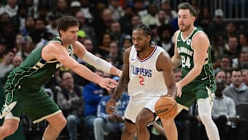 Mar 4, 2024; Milwaukee, Wisconsin, USA;  Los Angeles Clippers forward Kawhi Leonard (2) gets pressure from Milwaukee Bucks center Brook Lopez (11) and guard Pat Connaughton (24) in the third quarter at Fiserv Forum. Mandatory Credit: Benny Sieu-Imagn Images