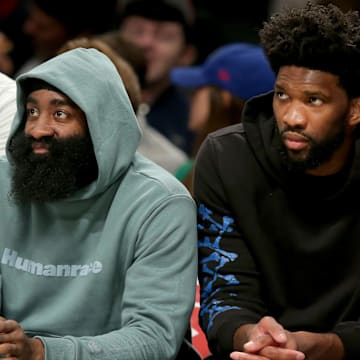 Oct 3, 2022; Brooklyn, New York, USA; Philadelphia 76ers guard James Harden (left) and Philadelphia 76ers center Joel Embiid watch from the bench during the second quarter against the Brooklyn Nets at Barclays Center. Mandatory Credit: Brad Penner-Imagn Images
