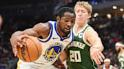 Oct 30, 2025; Milwaukee, Wisconsin, USA;  Golden State Warriors forward Jonathan Kuminga (1) drives for the basket again not Milwaukee Bucks guard AJ Green (20) in the second quarter at Fiserv Forum. Mandatory Credit: Benny Sieu-Imagn Images
