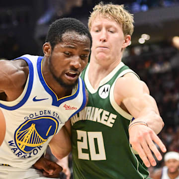 Oct 30, 2025; Milwaukee, Wisconsin, USA;  Golden State Warriors forward Jonathan Kuminga (1) drives for the basket again not Milwaukee Bucks guard AJ Green (20) in the second quarter at Fiserv Forum. Mandatory Credit: Benny Sieu-Imagn Images