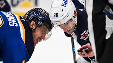 May 2, 2025; St. Louis, Missouri, USA; St. Louis Blues center Robert Thomas (18) and Winnipeg Jets center Morgan Barron (36) focus on the puck prior to a face-off during the third period in game six of the first round of the 2025 Stanley Cup Playoffs at Enterprise Center. Mandatory Credit: Connor Hamilton-Imagn Images