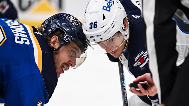 May 2, 2025; St. Louis, Missouri, USA; St. Louis Blues center Robert Thomas (18) and Winnipeg Jets center Morgan Barron (36) focus on the puck prior to a face-off during the third period in game six of the first round of the 2025 Stanley Cup Playoffs at Enterprise Center. Mandatory Credit: Connor Hamilton-Imagn Images