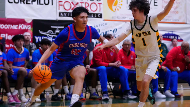 Coolidge guard Shane Enos (42) drives against San Tan Charter guard Peyton Lubash (1) during a game at San Tan Charter in Gilbert, Ariz. on Feb. 13, 2026.