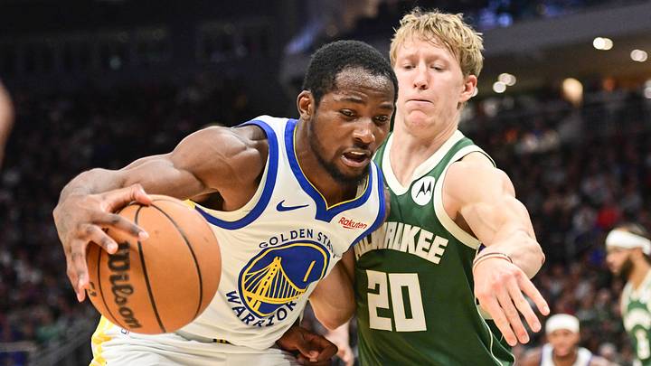 Oct 30, 2025; Milwaukee, Wisconsin, USA;  Golden State Warriors forward Jonathan Kuminga (1) drives for the basket again not Milwaukee Bucks guard AJ Green (20) in the second quarter at Fiserv Forum. Mandatory Credit: Benny Sieu-Imagn Images