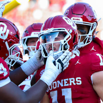 Oklahoma Sooners quarterback Jackson Arnold (11) celebrates with teammates after scoring a touchdown.