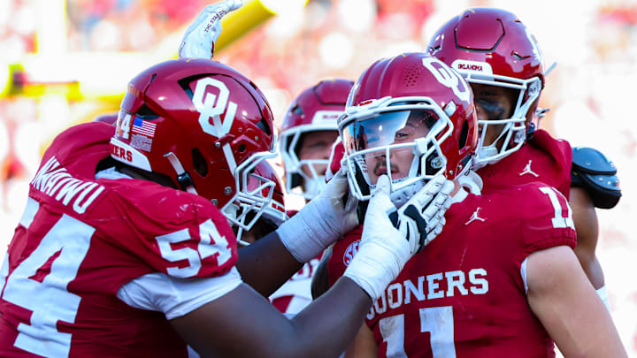 Oklahoma Sooners quarterback Jackson Arnold (11) celebrates with teammates after scoring a touchdown.