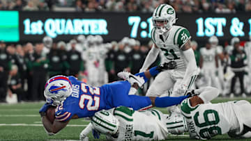 Oct 14, 2024; East Rutherford, New Jersey, USA; Buffalo Bills running back Ray Davis (22) dives but lands short of a touchdown as New York Jets cornerback Sauce Gardner (1) makes a tackle during the first half at MetLife Stadium. Mandatory Credit: Lucas Boland-Imagn Images