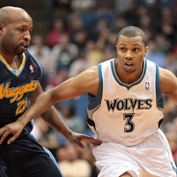 Feb 5, 2011; Minneapolis, MN, USA; Minnesota Timberwolves guard Sebastian Telfair (3) dribbles around Denver Nuggets guard Anthony Carter (25) during the second half at Target Center. The Nuggets won 113-100. Mandatory Credit: Jesse Johnson-Imagn Images