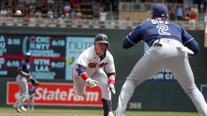 Jun 11, 2022; Minneapolis, Minnesota, USA; Tampa Bay Rays third baseman Yandy Diaz (2) awaits the throw to tag out Minnesota Twins third baseman Jose Miranda (64) on his RBI double which he tried to stretch into a triple in the third inning at Target Field. Mandatory Credit: Bruce Kluckhohn-Imagn Images