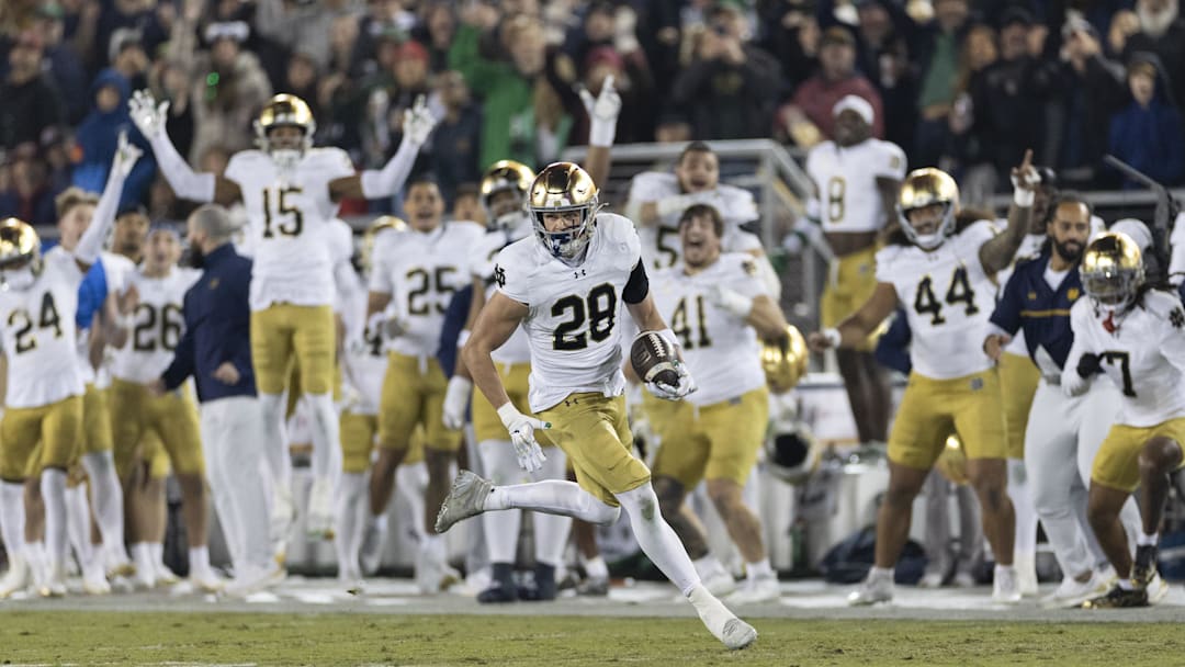 Nov 29, 2025; Stanford, California, USA;   Notre Dame Fighting Irish safety Luke Talich (28) runs for a touchdown on a fake punt against the Stanford Cardinal during the second quarter at Stanford Stadium.