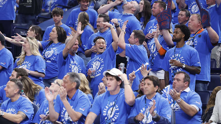 May 9, 2024; Oklahoma City, Oklahoma, USA; Oklahoma City Thunder fans cheer as their team scores against the Dallas Mavericks during the second quarter of game two of the second round for the 2024 NBA playoffs at Paycom Center. Mandatory Credit: Alonzo Adams-Imagn Images