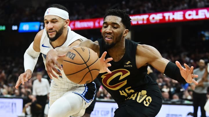 May 5, 2024; Cleveland, Ohio, USA; Cleveland Cavaliers guard Donovan Mitchell (45) goes for a loose ball against Orlando Magic guard Jalen Suggs (4) during the first half in game seven of the first round for the 2024 NBA playoffs at Rocket Mortgage FieldHouse. Mandatory Credit: Ken Blaze-USA TODAY Sports