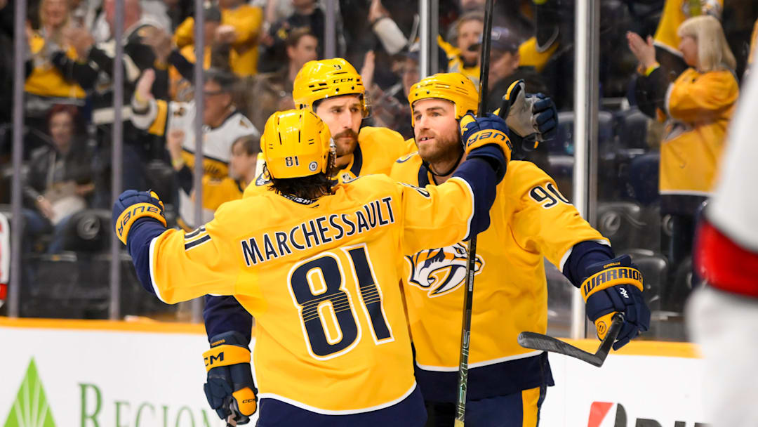 Dec 23, 2024; Nashville, Tennessee, USA;  Nashville Predators center Ryan O'Reilly (90) celebrates his goal with his teammates  against the Carolina Hurricanes during the third period at Bridgestone Arena. Mandatory Credit: Steve Roberts-Imagn Images