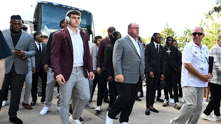 Aug 31, 2024; College Station, Texas, USA; Texas A&M Aggies quarterback Conner Weigman, left, and head coach Mike Elko, right, arrive prior to the game against the Notre Dame Fighting Irish at Kyle Field. Mandatory Credit: Maria Lysaker-USA TODAY Sp