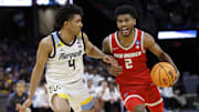New Mexico guard Donovan Dent is defended by Marquette Golden guard Stevie Mitchell.