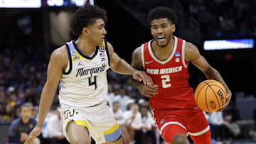 New Mexico guard Donovan Dent is defended by Marquette Golden guard Stevie Mitchell.