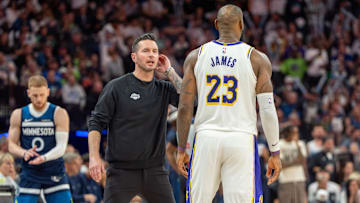 Apr 27, 2025; Minneapolis, Minnesota, USA; Los Angeles Lakers head coach JJ Redick talks with forward LeBron James (23) in the fourth quarter against the Minnesota Timberwolves during game four of first round for the 2025 NBA Playoffs at Target Center. Mandatory Credit: Matt Blewett-Imagn Images