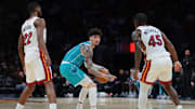 Oct 28, 2025; Miami, Florida, USA; Charlotte Hornets guard Lamelo Ball (1) proctects the basketball from Miami Heat forward Andrew Wiggins (22) and guard Davion Mitchell (45) during the second quarter at Kaseya Center. Mandatory Credit: Sam Navarro-Imagn Images