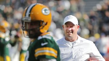 Green Bay Packers offensive coordinator Nathaniel Hackett talks with quarterback Aaron Rodgers (12)
