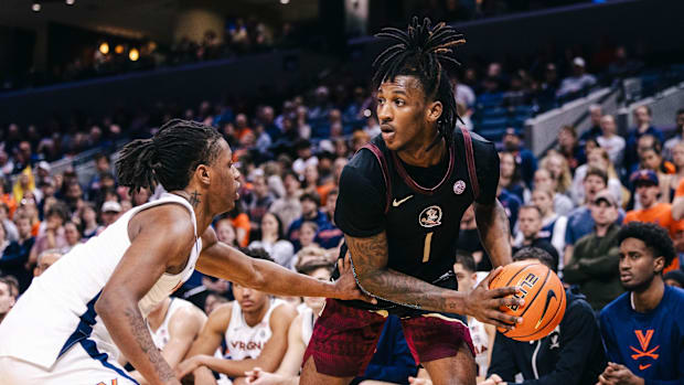 Florida State Seminoles guard Jamir Watkins (1) controls the ball while Virginia Cavaliers guard Dai Dai Ames (7)