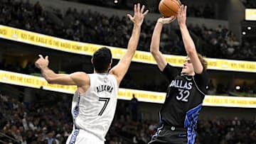 Nov 22, 2025; Dallas, Texas, USA; Dallas Mavericks forward Cooper Flagg (32) makes a jump shot over Memphis Grizzlies forward Santi Aldama (7) during the second quarter at the American Airlines Center. Mandatory Credit: Jerome Miron-Imagn Images