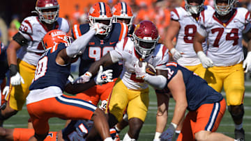 Sep 27, 2025; Champaign, Illinois, USA;  Southern California Trojans running back Waymond Jordan (2) runs through the Illinois Fighting Illini defensive line during the second half at Memorial Stadium. Mandatory Credit: Ron Johnson-Imagn Images