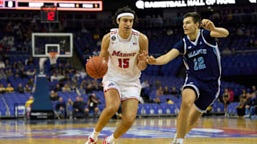 Dec 4, 2022; London, ENG;  Marist Red Foxes center Patrick Gardner (15) controls the ball  under pressure from Maine Black Bears guard Gedi Juozapaitis (22) during the first half at The O2 Arena. Mandatory Credit: Peter van den Berg-Imagn Images