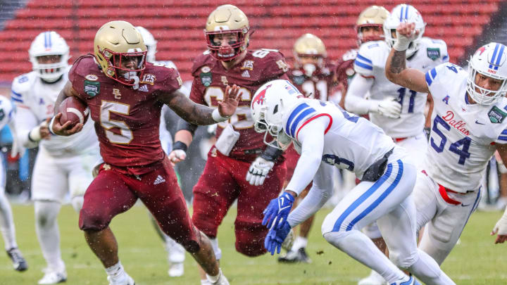 Boston College's Kye Robichaux stiff-arms SMU's Alexander Kilgore during the second annual Wasabi Fenway Bowl vs. SMU at Fenway Park on Thursday, Dec. 28, 2023.