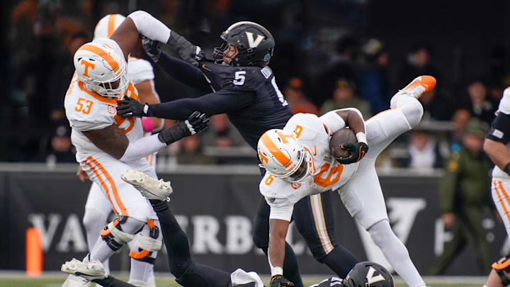 Tennessee running back Dylan Sampson (6) is stopped by Vanderbilt safety CJ Taylor (1) during the third quarter at FirstBank Stadium in Nashville, Tenn., Saturday, Nov. 30, 2024.