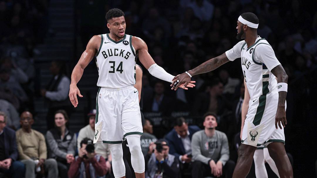 Dec 27, 2023; Brooklyn, New York, USA; Milwaukee Bucks forward Giannis Antetokounmpo (34) slaps hands with forward Bobby Portis (9) during the first half against the Brooklyn Nets at Barclays Center. Mandatory Credit: Vincent Carchietta-Imagn Images