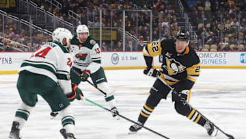 Nov 21, 2025; Pittsburgh, Pennsylvania, USA;  Pittsburgh Penguins right wing Sam Poulin (22) shoots the puck as Minnesota Wild defenseman Zach Bogosian (24) defends during the third period  at PPG Paints Arena. Mandatory Credit: Charles LeClaire-Imagn Images