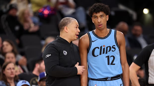 Los Angeles Clippers head coach, Tyronn Lue (left), talks to keep Cam Christie 