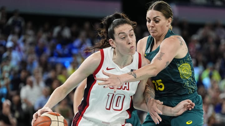 Aug 9, 2024; Paris, France; United States power forward Breanna Stewart (10) is defended by Australia forward Cayla George (15)  in a women's basketball semifinal game during the Paris 2024 Olympic Summer Games at Accor Arena. Mandatory Credit: Sarah Phipps-USA TODAY Sports