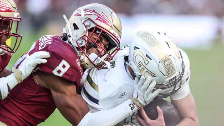 Aug 24, 2024; Dublin, IRL; Florida State defensive back Azareyeíh Thomas tackles Georgia Tech quarterback Haynes King at Aviva Stadium. Mandatory Credit: Tom Maher/INPHO via USA TODAY Sports