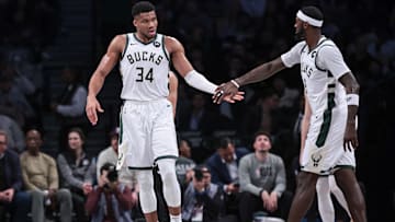 Dec 27, 2023; Brooklyn, New York, USA; Milwaukee Bucks forward Giannis Antetokounmpo (34) slaps hands with forward Bobby Portis (9) during the first half against the Brooklyn Nets at Barclays Center. Mandatory Credit: Vincent Carchietta-Imagn Images
