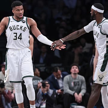 Dec 27, 2023; Brooklyn, New York, USA; Milwaukee Bucks forward Giannis Antetokounmpo (34) slaps hands with forward Bobby Portis (9) during the first half against the Brooklyn Nets at Barclays Center. Mandatory Credit: Vincent Carchietta-Imagn Images