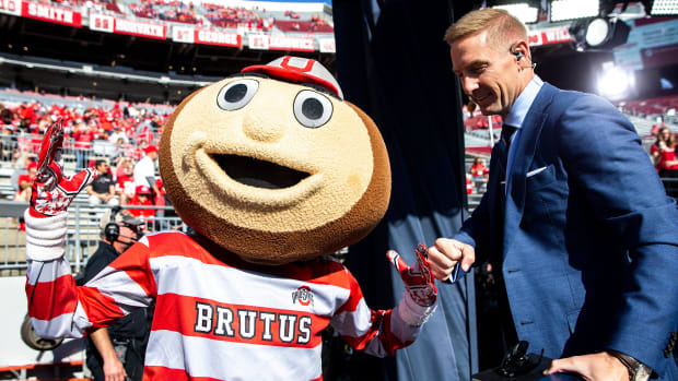 Brutus greets Joel Klatt before a NCAA football game between Iowa and Ohio State, Saturday, Oct. 22,